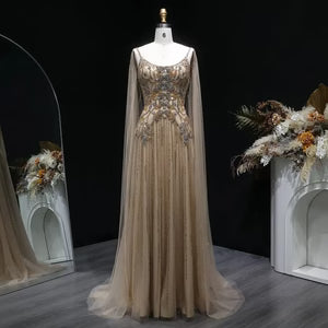 The Aurore — Champagne Beaded Glitter Sheer Cape Mermaid Gown