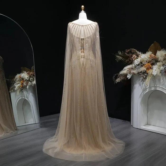 The Aurore — Champagne Beaded Glitter Sheer Cape Mermaid Gown